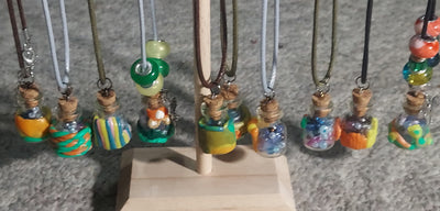 Unique handcrafted necklace featuring mini jar pendant with creative embellishments