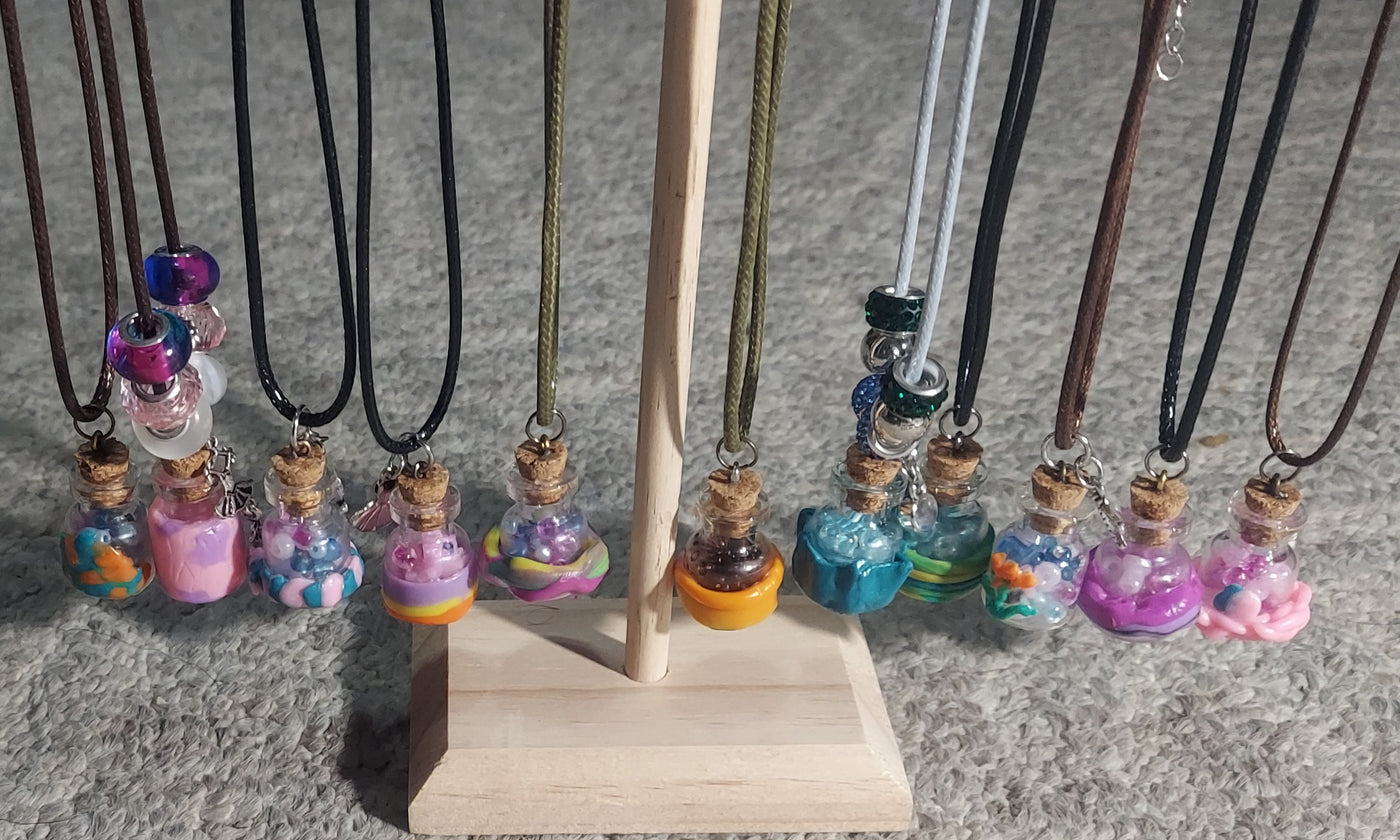 Unique handcrafted necklace featuring mini jar pendant with creative embellishments