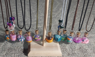 Unique handcrafted necklace featuring mini jar pendant with creative embellishments